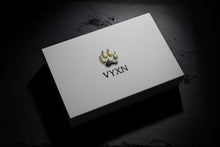 White card with a logo and 'VYXN' text on a dark textured background