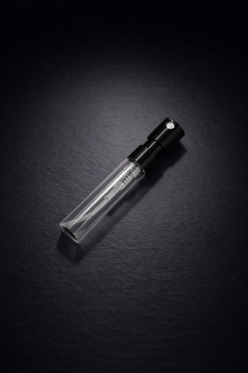 Empty sample 2 ml perfume bottle with black background