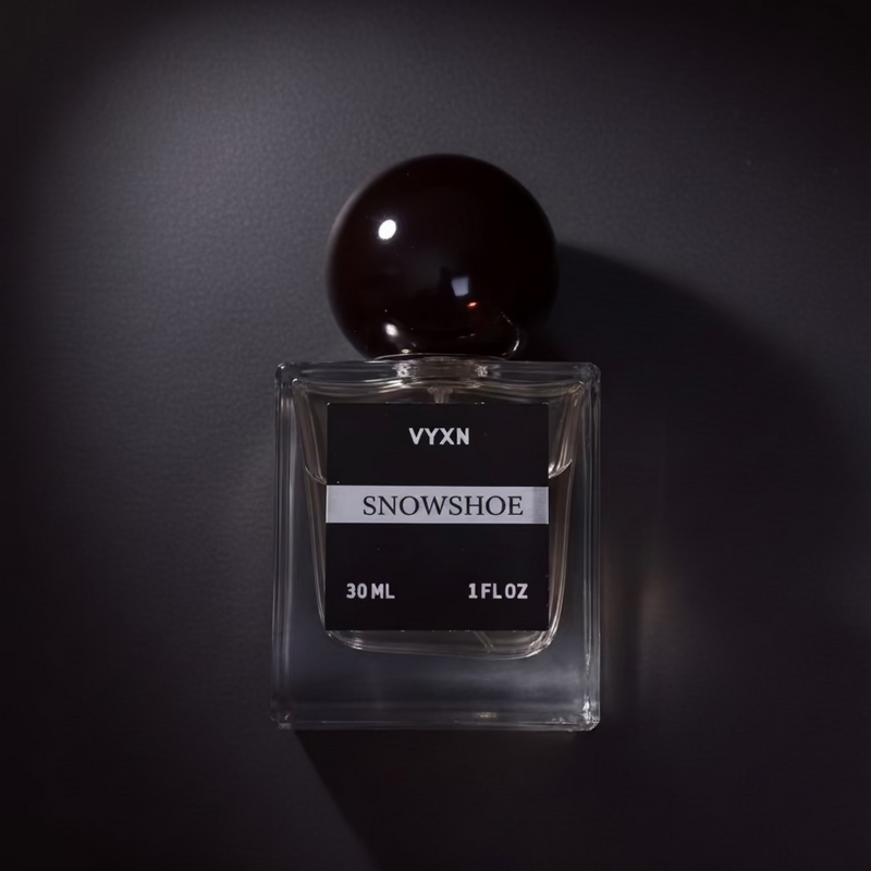 perfume bottle labeled snowshoe, black background