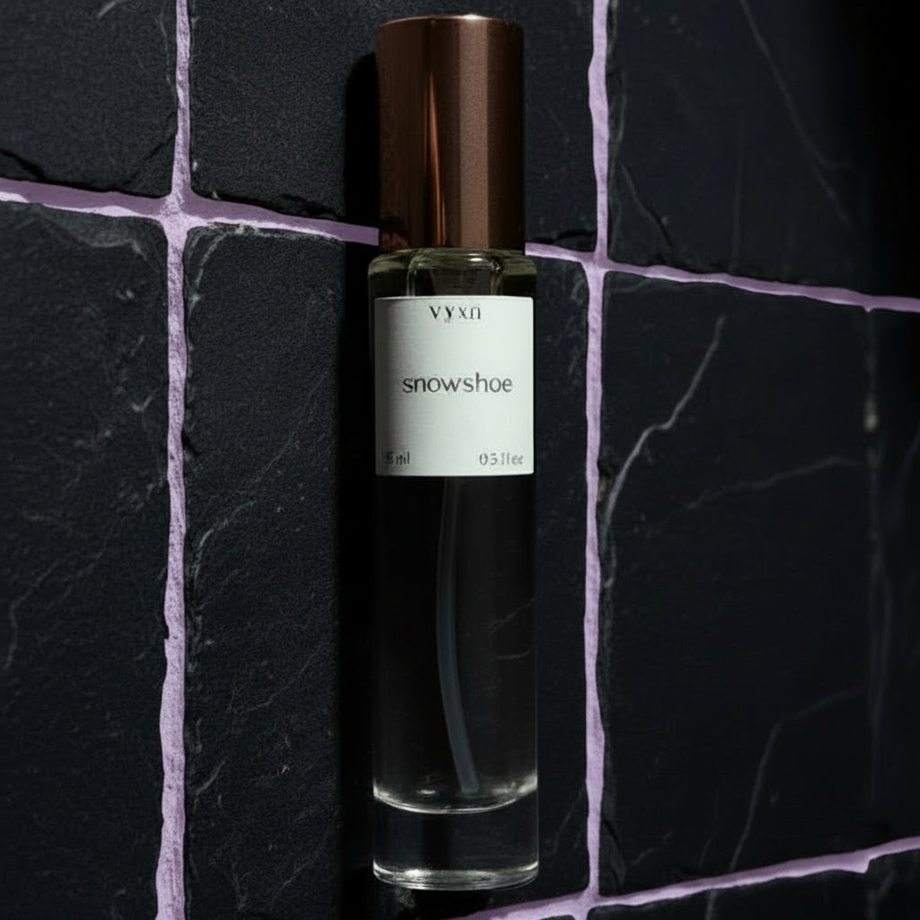 Vynn Snowshoe perfume bottle on a dark stone surface