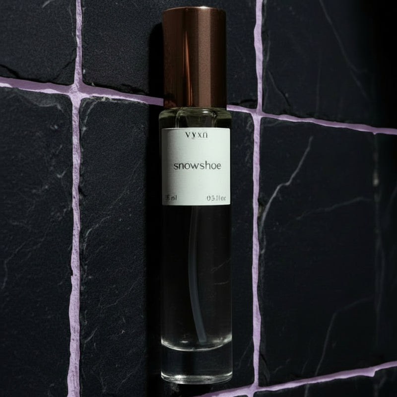 Vynn Snowshoe perfume bottle on a dark stone surface