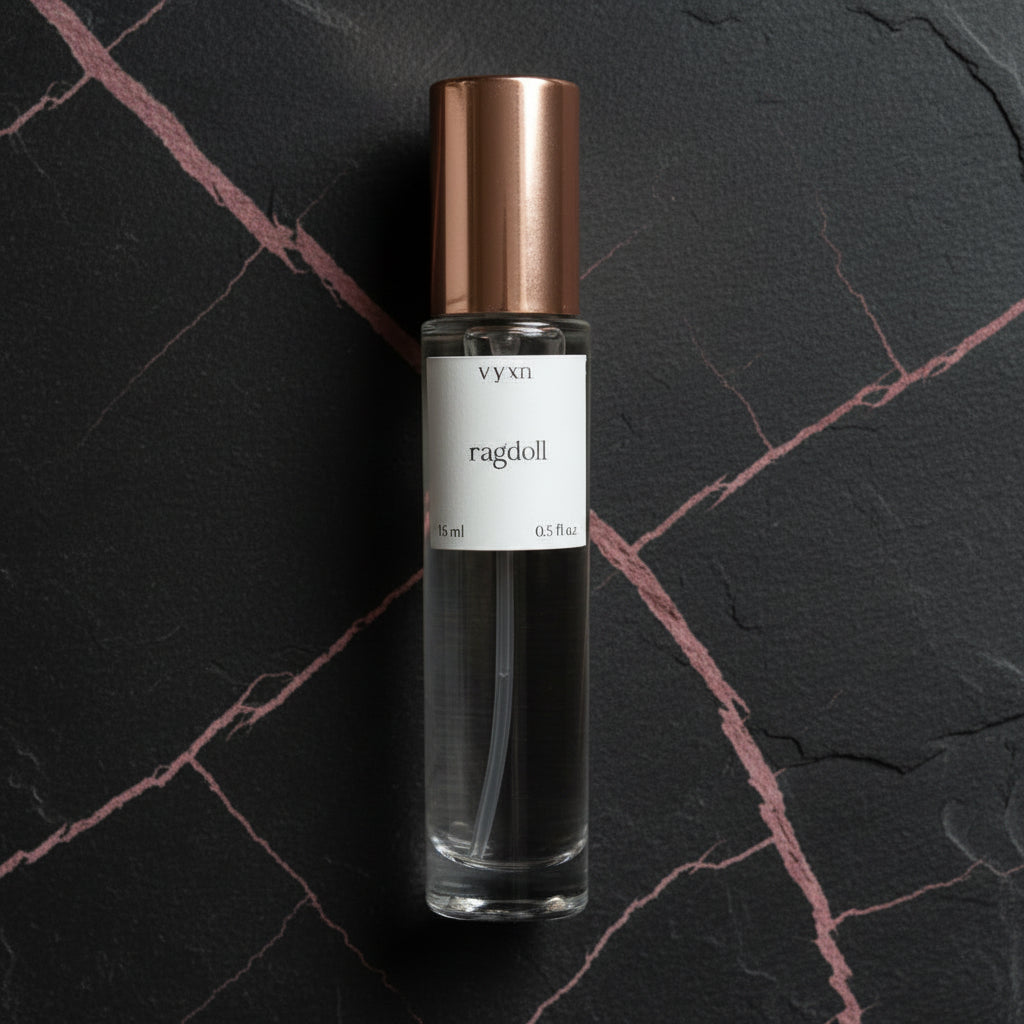 Perfume bottle with copper cap on a dark surface