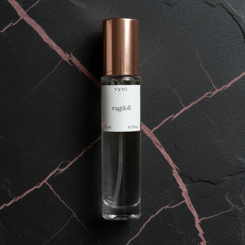 Perfume bottle with copper cap on a dark surface