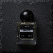 Angora perfume bottle black background. 