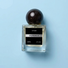 Perfume bottle labeled VYXN SNOWSHOE 30 ml 1 fl.oz. background white silk. label is back and silver