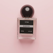 Perfume bottle labeled VYXN Ragdoll 30 ml 1 fl.oz. background white silk. label is back and silver
