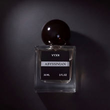 Perfume bottle labeled 'VYXN Abyssinian' on a dark background